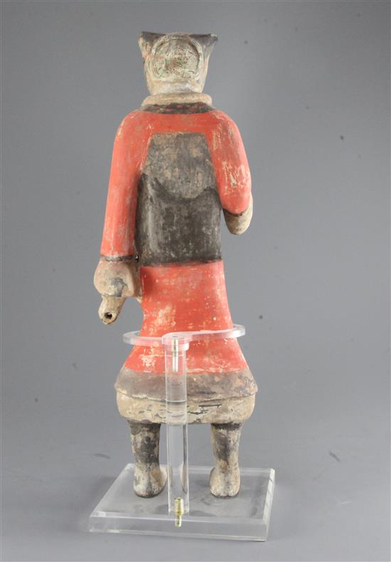 A large Chinese polychrome pottery figure of a standing soldier, Han dynasty (206BC - 220AD), 44.5cm, modern stand